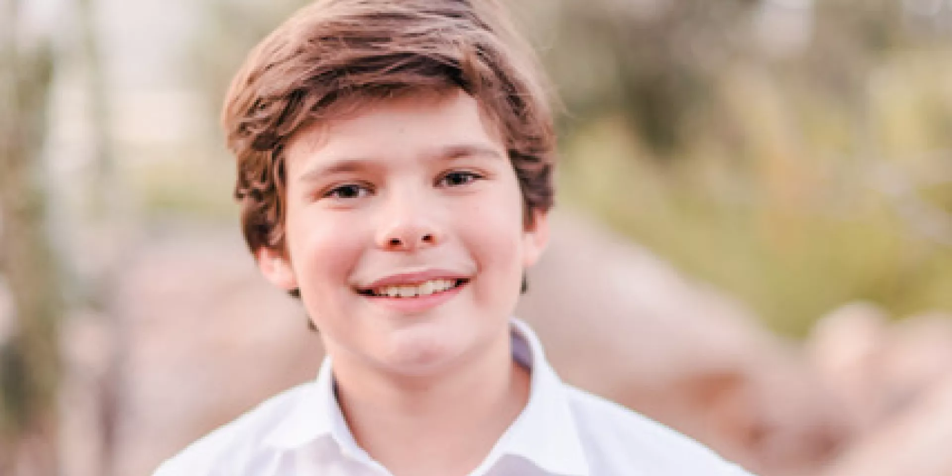 Karsten Knodell  Karsten, a young boy wearing a white shirt, standing facing the camera