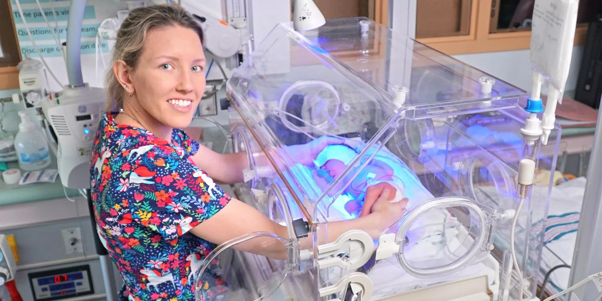 special care nursery  nurse standing next to incubator in special care nursery
