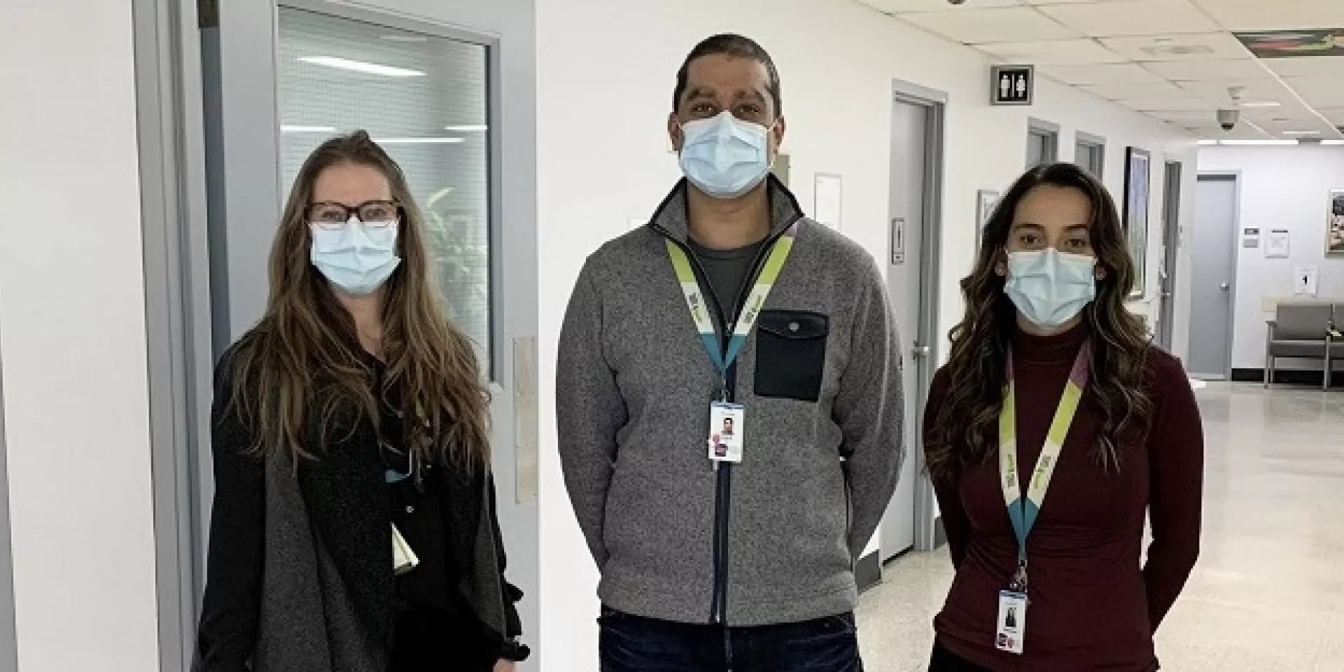 Adina Hauser (left) with TYP team members Amil Riaz and Vanessa DaCosta three people standing in corridor facing the camera