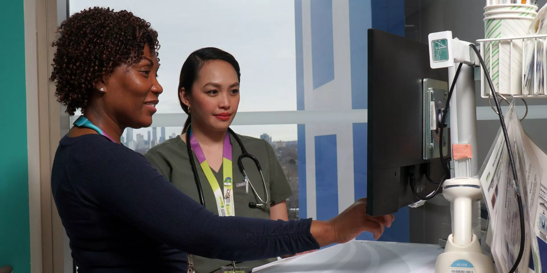 Supervisor Ann Marie Palmer and Registered Nurse Gwynn Fernandez collaborating on patient care. Supervisor Ann Marie Palmer and Registered Nurse Gwynn Fernandez collaborating on patient care.