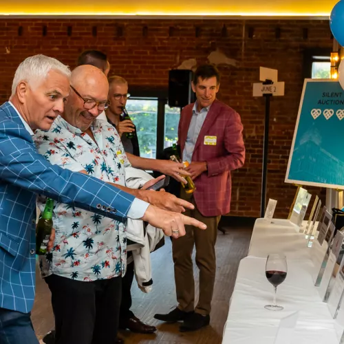 Checking out the silent auction at East End Eats Two guests at the silent auction table