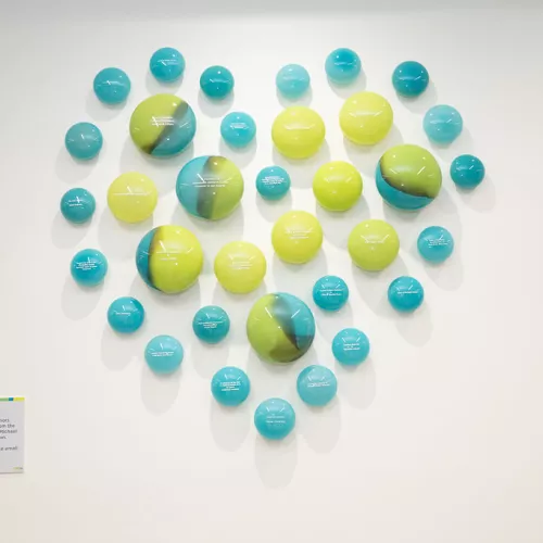 From the Heart is comprised of engraved glass orbs featured by the lobby in the Ken and Marilyn Thomson Patient Care Centre multiple glass orbs making the shape of a heart together on the wall.