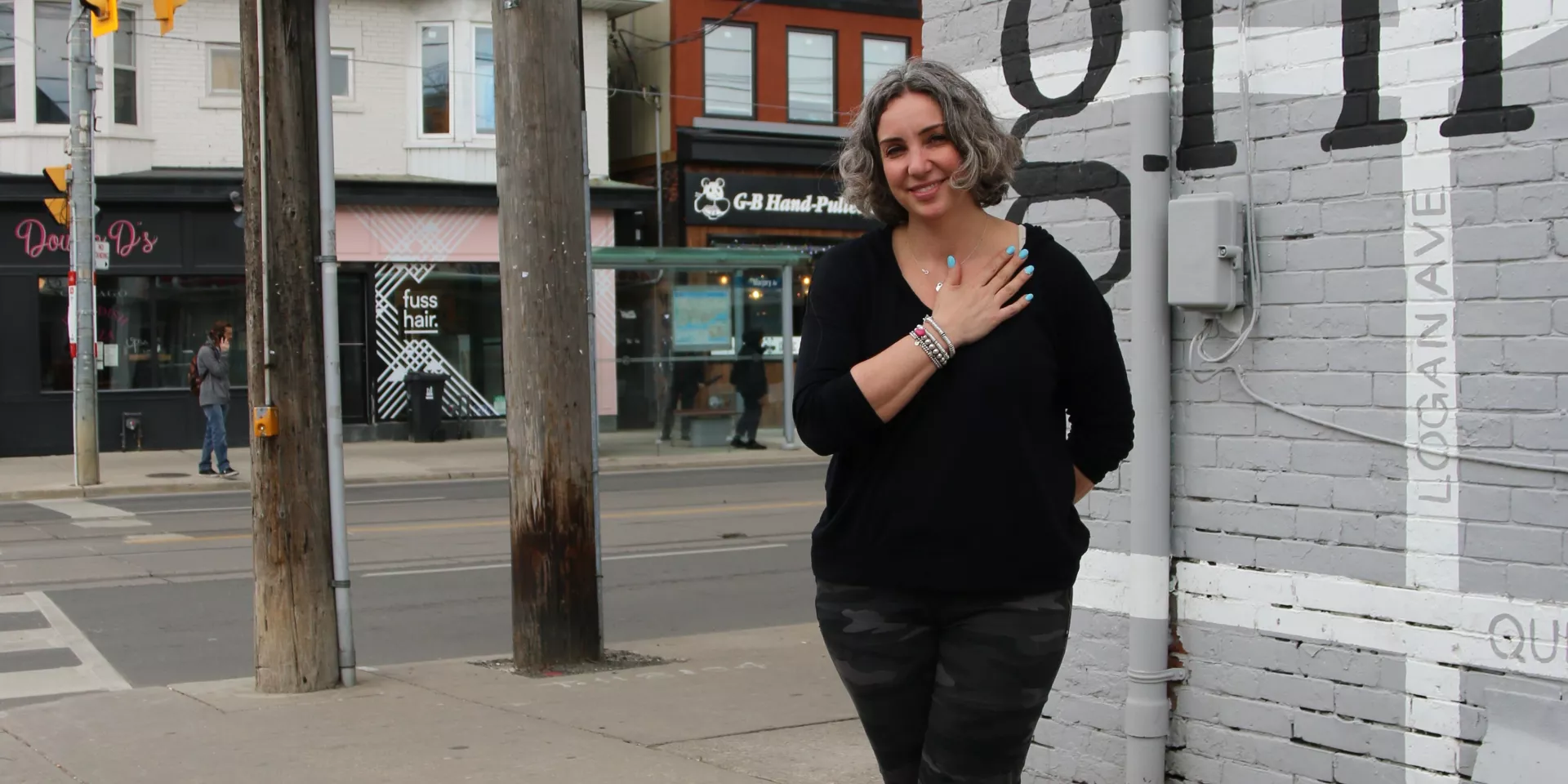 woman standing in front of coffee shop 