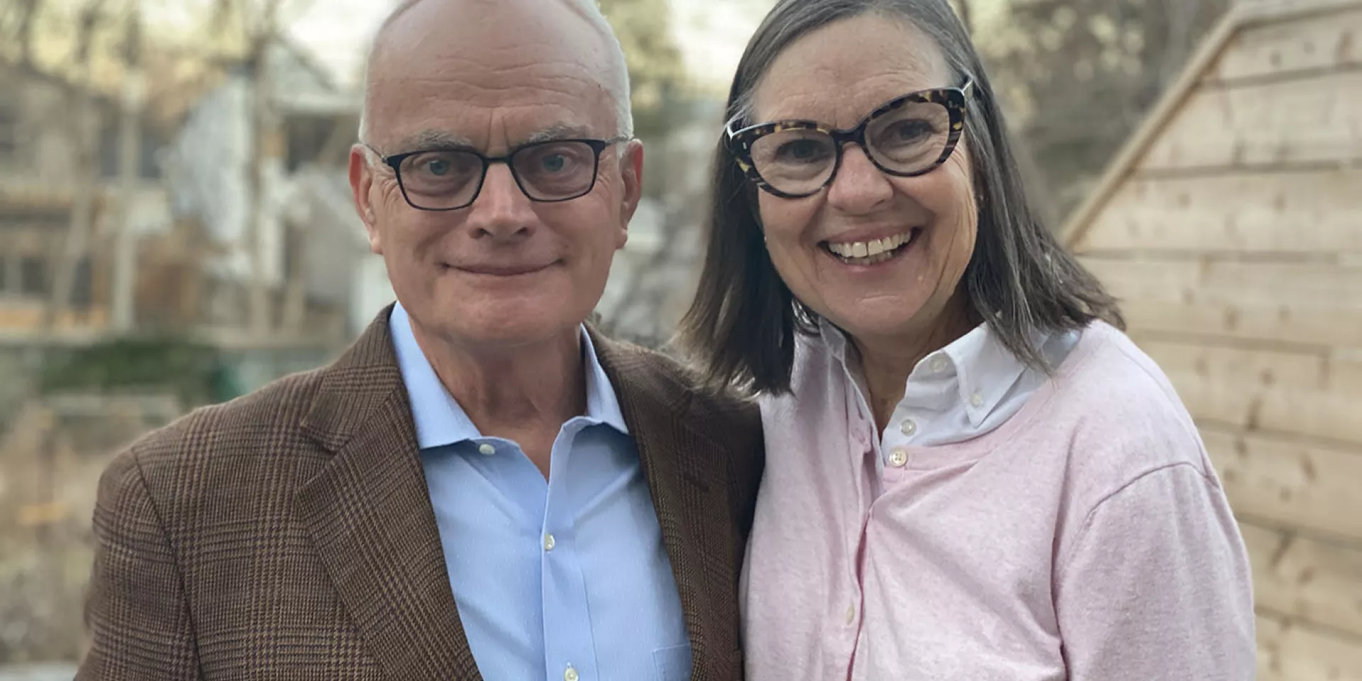 Jack Gibbons with his wife, Mary Lovett. (Photo credit: Josh Clavir) Image of Jack Gibbons and his wife Mary Lovett smiling outside.
