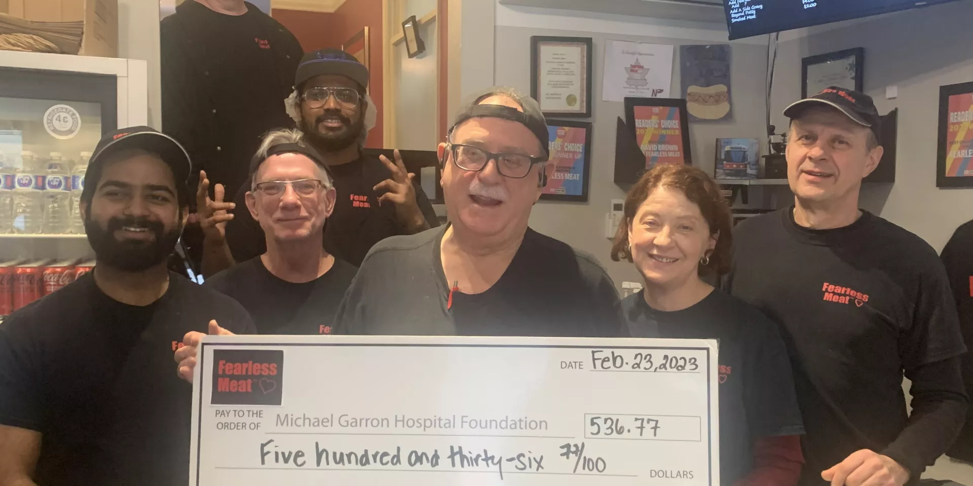 Staff of Fearless Meat presenting their gift to MGH