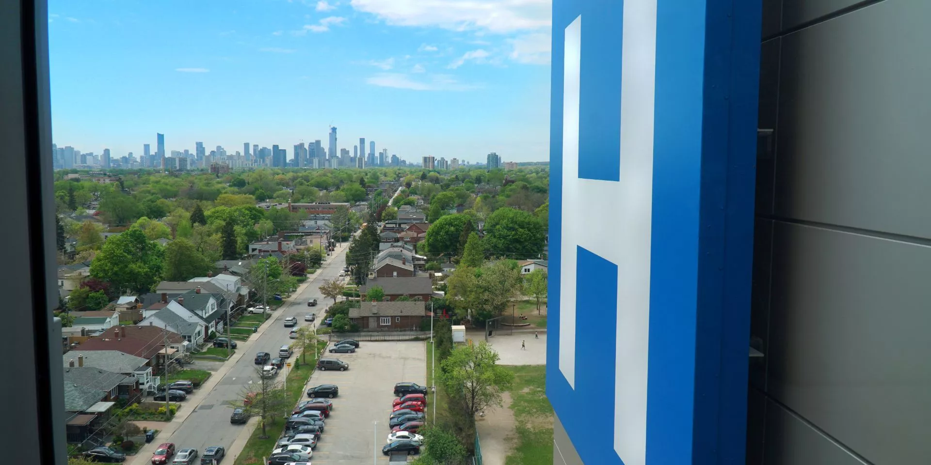 Michael Garron Hospital Blue "H" sign overlooking the neighbourhood around the hospital