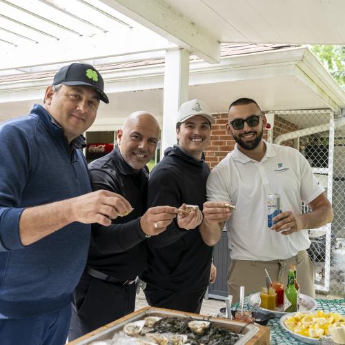 Golfers eating oysters
