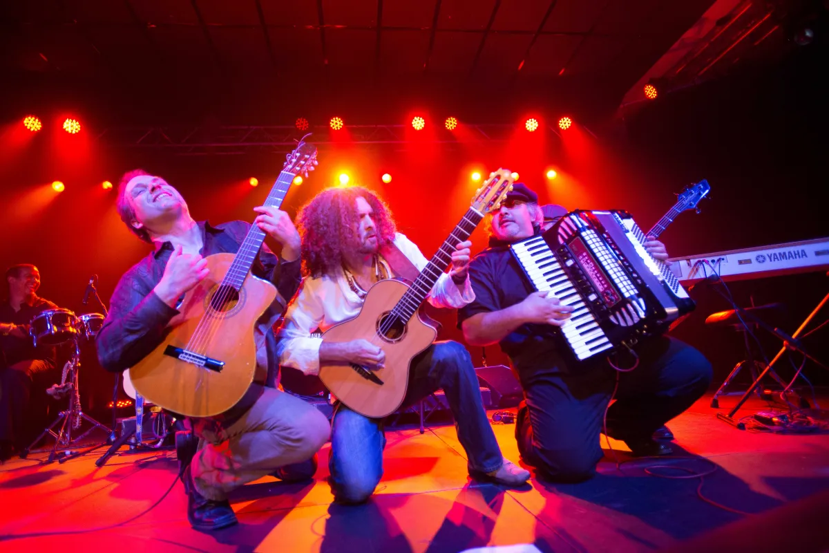 Three performers on stage