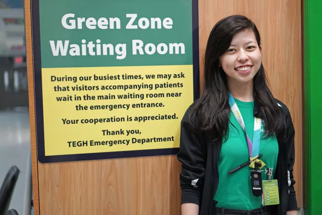Woman standing in front of sign 