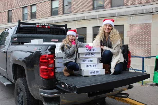 East Toronto resident Richelle Johnston and daughter Sydney, age six, unload Love Boxes at Michael Garron Hospital.