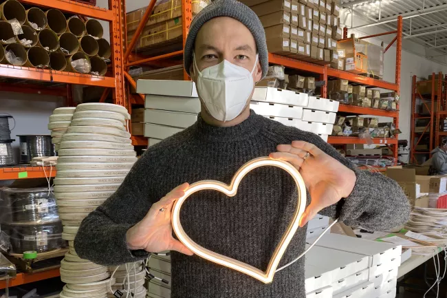 man holding LED heart