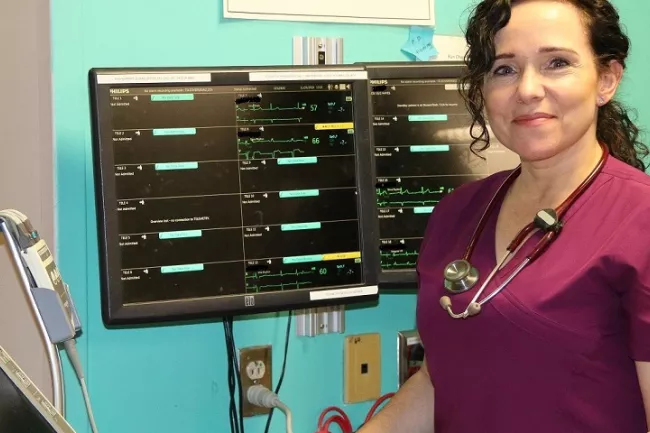 Nurse standing in front of monitor 