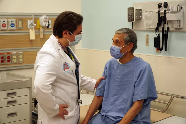 Dr. Carmine Simone, Vice President, Medical, Strategic Clinical Partnerships and Innovation, meets with a patient.